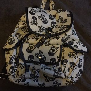 It’s a beige-ish skull printed backpack